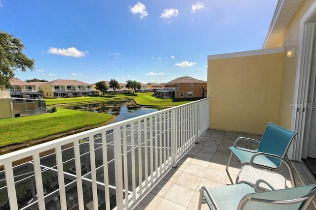 balcony with a residential view and a water view