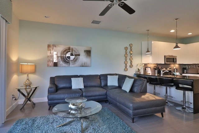 living room with recessed lighting, visible vents, ceiling fan, and baseboards