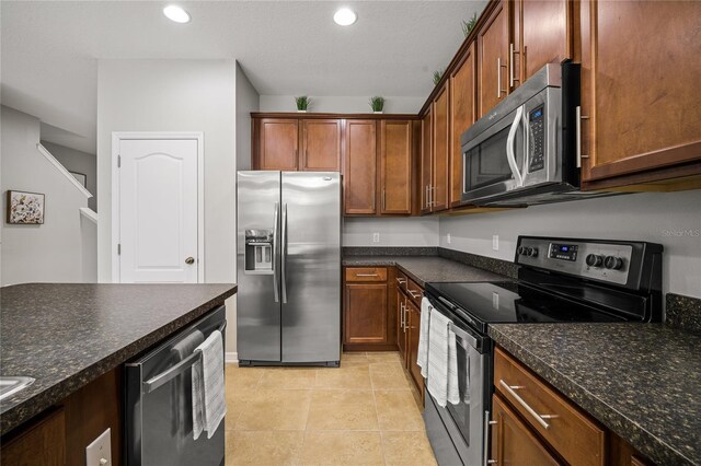 kitchen featuring appliances with stainless steel finishes and light tile patterned floors