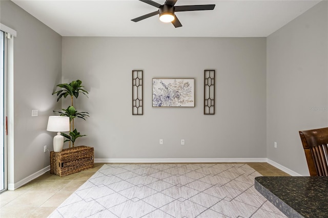 sitting room with ceiling fan and light tile patterned floors