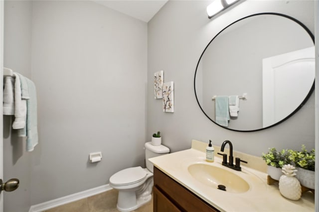 bathroom featuring tile patterned flooring, vanity, and toilet