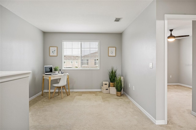 office space featuring light carpet and ceiling fan