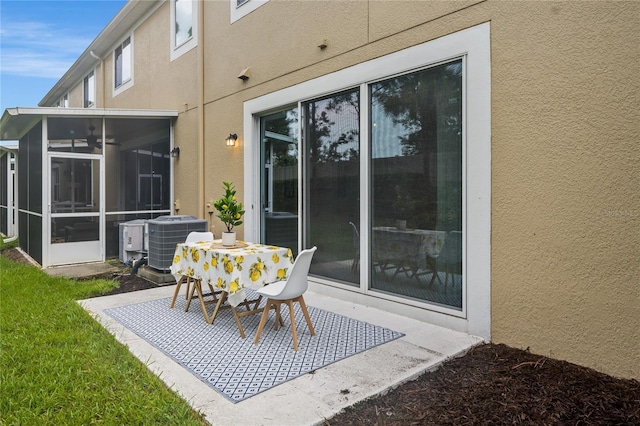 view of patio / terrace featuring cooling unit and a sunroom