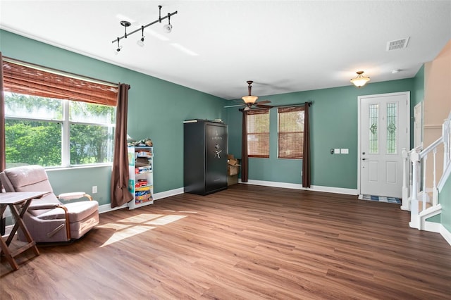 living area with hardwood / wood-style flooring and ceiling fan