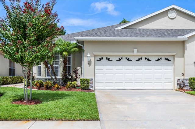 ranch-style house featuring a garage and a front yard