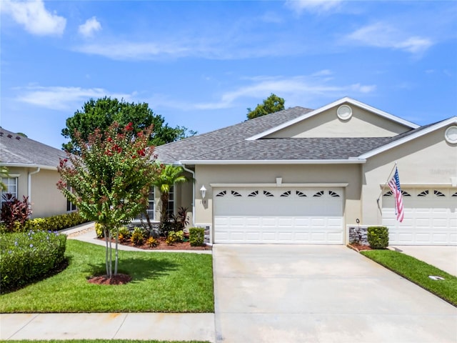 ranch-style house with a garage and a front yard