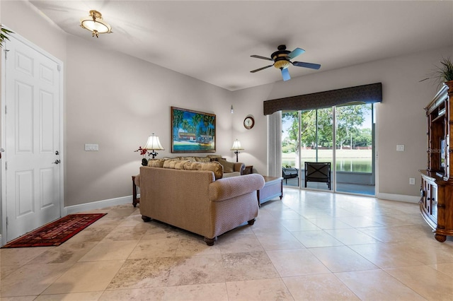 living room featuring light tile patterned flooring and ceiling fan