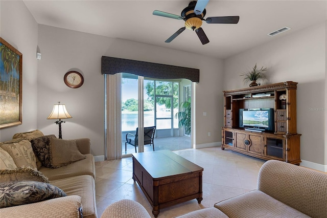 tiled living room with ceiling fan