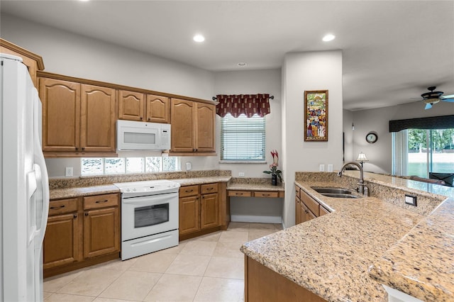 kitchen featuring white appliances, sink, kitchen peninsula, light tile patterned flooring, and ceiling fan