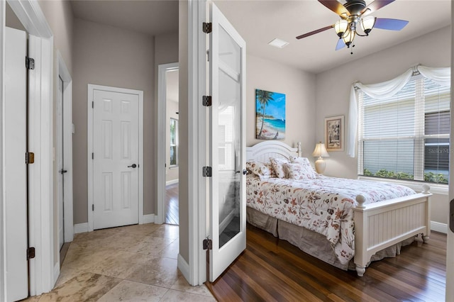 bedroom with ceiling fan and hardwood / wood-style floors