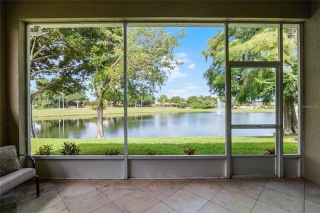 unfurnished sunroom featuring a water view