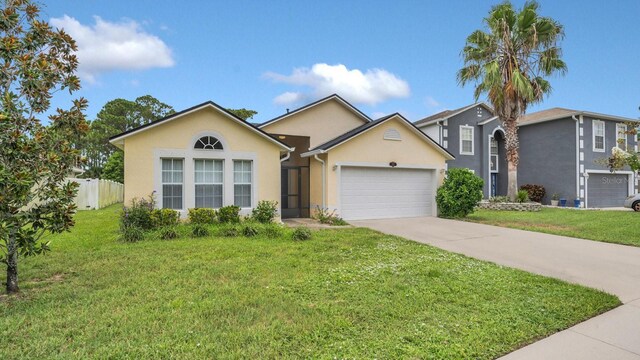 view of front of property featuring a garage and a front yard