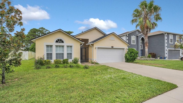 view of front of property featuring a garage and a front lawn