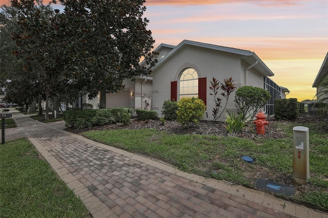 view of front of house featuring an attached garage and stucco siding