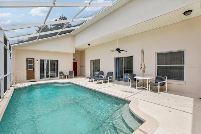 view of pool featuring a lanai, a patio, and ceiling fan