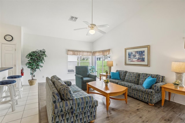 living room featuring high vaulted ceiling, light wood-type flooring, and ceiling fan