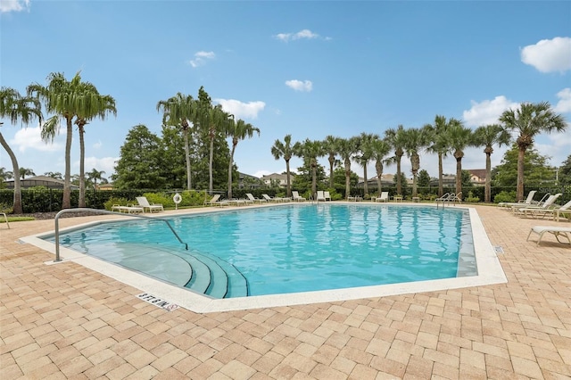 pool featuring a patio area and fence