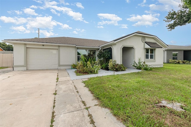 single story home featuring a garage and a front lawn