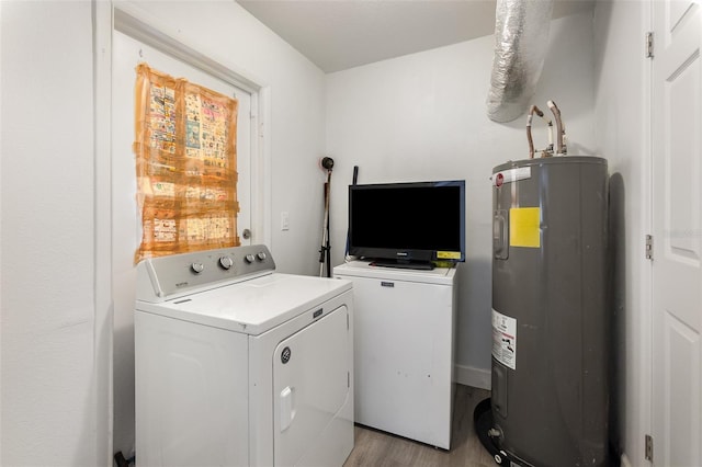 washroom featuring electric water heater, independent washer and dryer, and light wood-type flooring