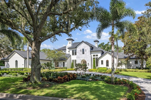 mediterranean / spanish-style house with a front yard