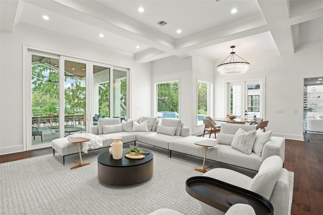 living room featuring beam ceiling, an inviting chandelier, french doors, and dark wood-type flooring