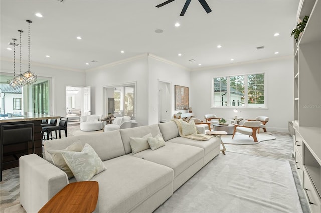 living room featuring ceiling fan and ornamental molding