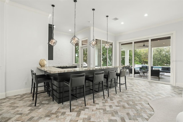 interior space featuring ceiling fan and crown molding