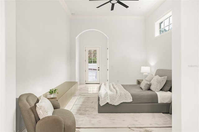 bedroom featuring multiple windows, ceiling fan, and ornamental molding