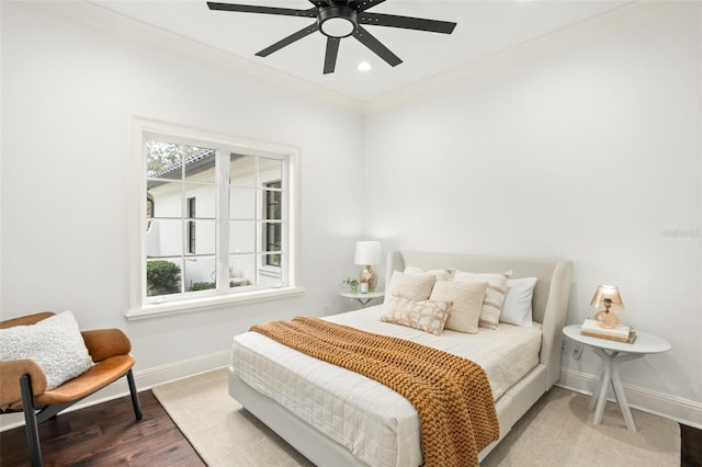 bedroom featuring ceiling fan, hardwood / wood-style floors, and crown molding