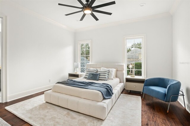 bedroom featuring hardwood / wood-style floors, ceiling fan, and crown molding