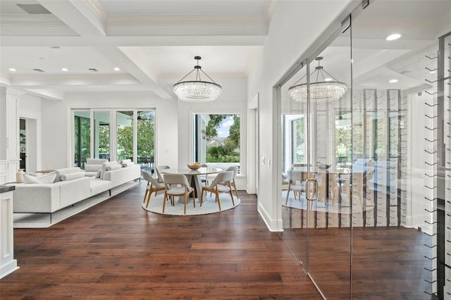 dining space featuring a chandelier, beam ceiling, and a wealth of natural light