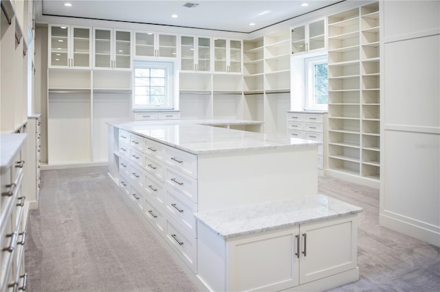 spacious closet featuring light carpet