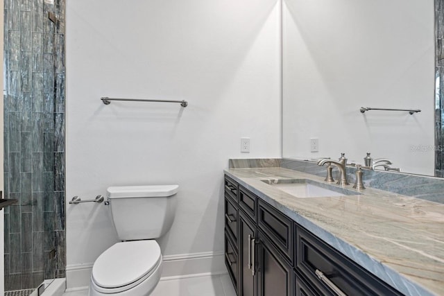 bathroom featuring tile patterned flooring, vanity, toilet, and a tile shower