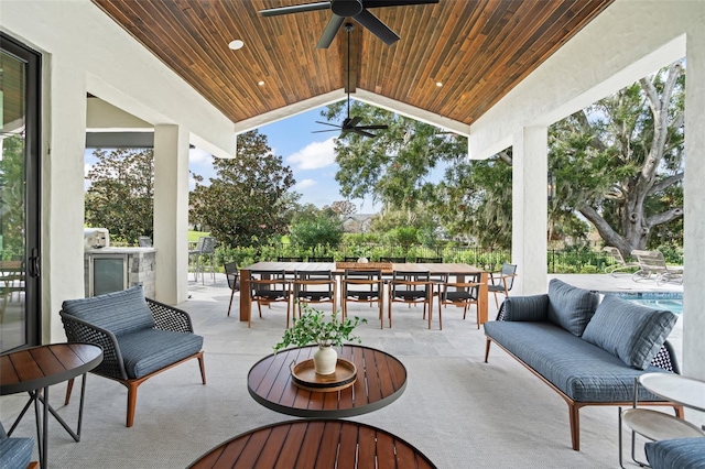 view of patio featuring outdoor lounge area, ceiling fan, and exterior kitchen