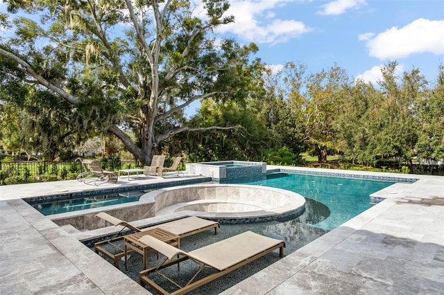 view of pool with an in ground hot tub and a patio