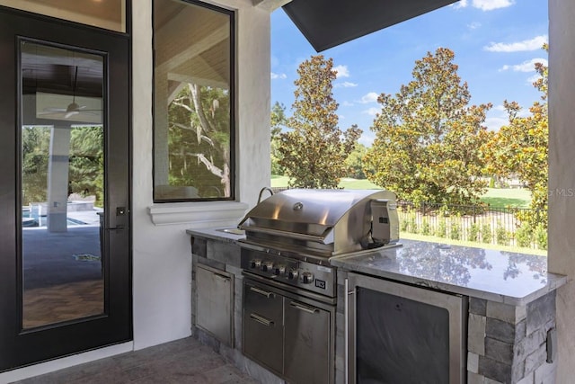 view of patio / terrace featuring a grill and an outdoor kitchen