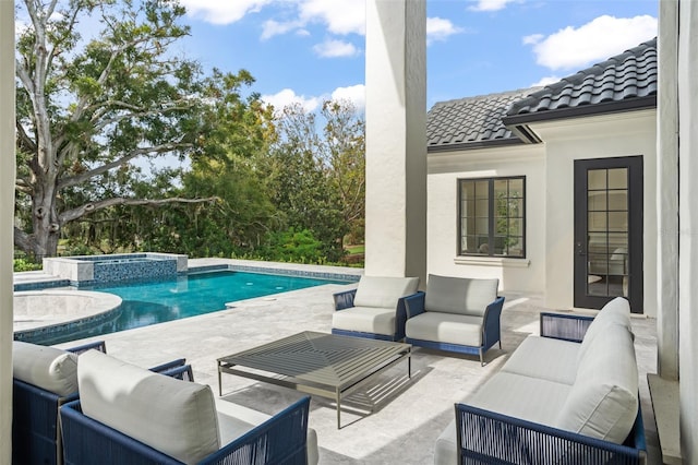 view of pool with an in ground hot tub, an outdoor living space, and a patio