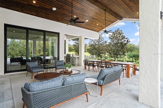 view of patio / terrace featuring ceiling fan, exterior kitchen, and an outdoor hangout area