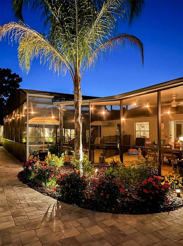 back house at twilight with a patio