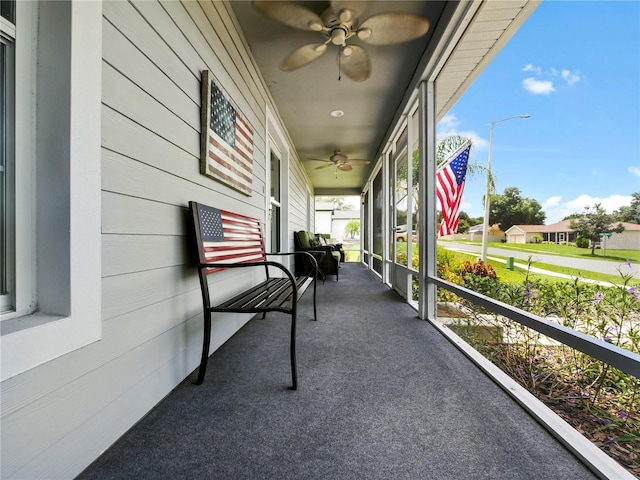 exterior space featuring ceiling fan and a balcony