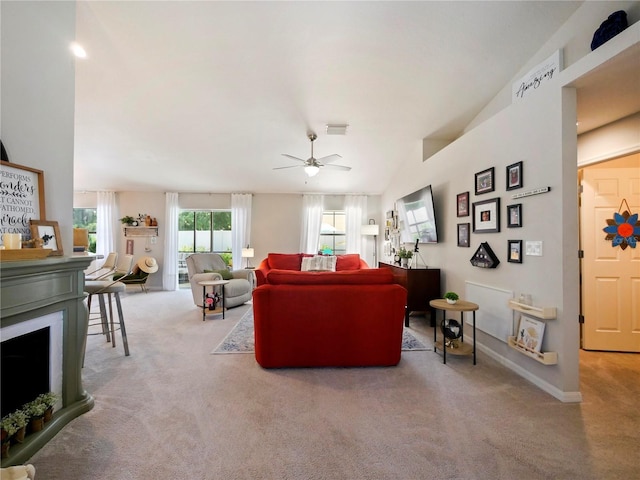 living room with vaulted ceiling, light colored carpet, and ceiling fan