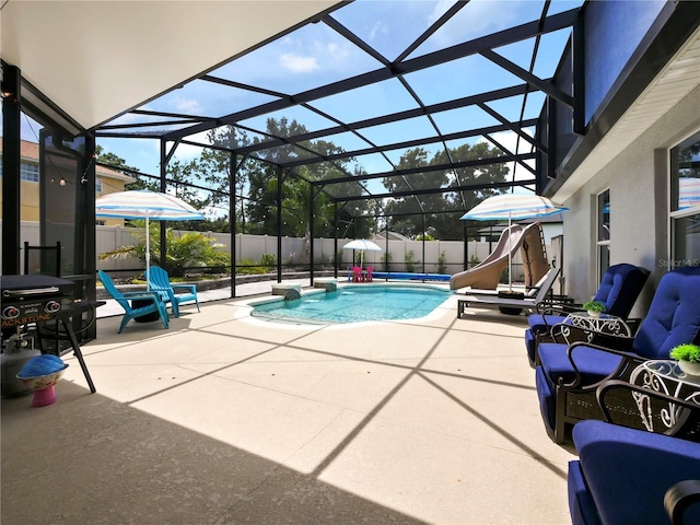 view of pool featuring a water slide, a lanai, and a patio area