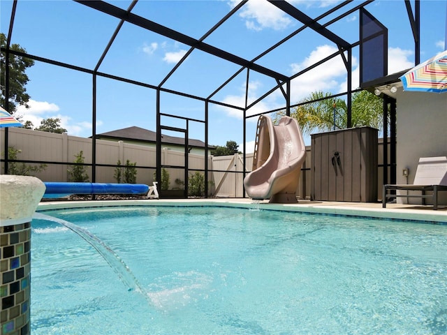 view of pool featuring a lanai and a water slide