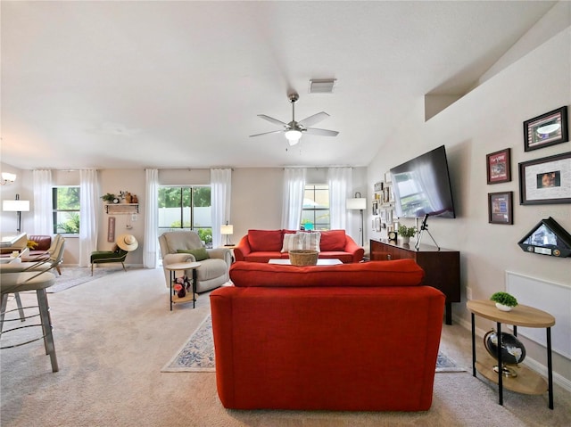 carpeted living room featuring ceiling fan and lofted ceiling