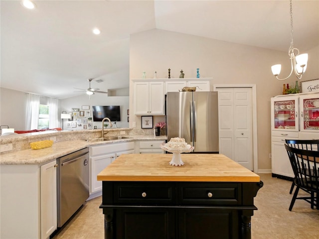 kitchen featuring white cabinetry, appliances with stainless steel finishes, a center island, and sink