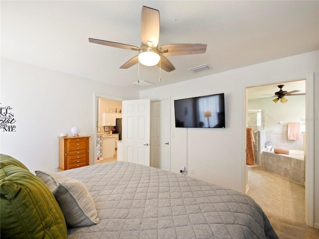 carpeted bedroom with ensuite bath and ceiling fan