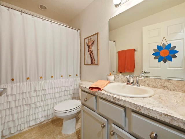 bathroom with vanity, wood-type flooring, and toilet