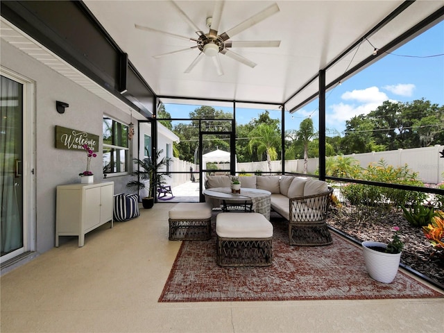 sunroom featuring a wealth of natural light and ceiling fan