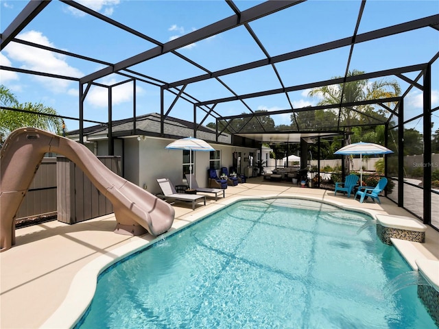 view of pool featuring pool water feature, a water slide, a lanai, and a patio area