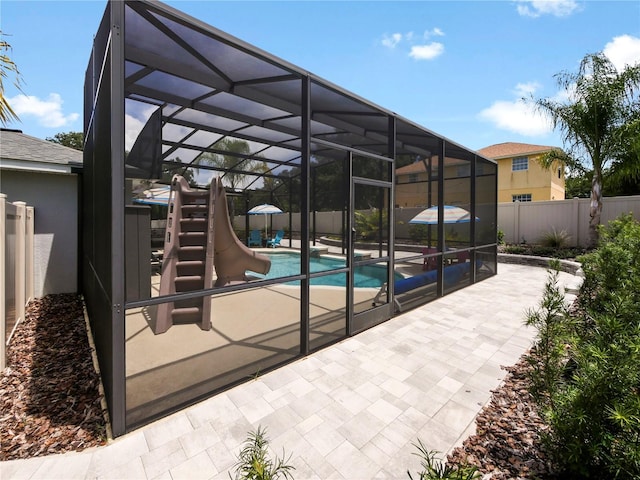 view of patio with a fenced in pool and glass enclosure